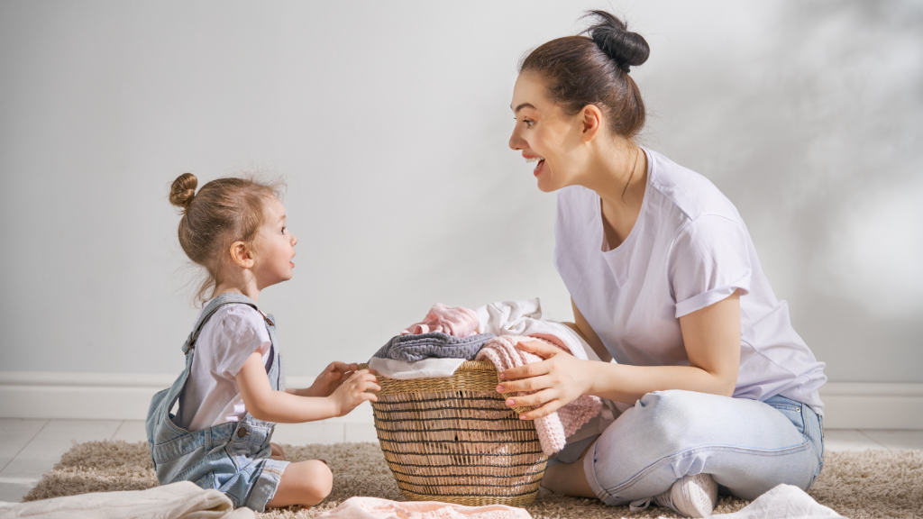 Mother and daughter folding laundry together