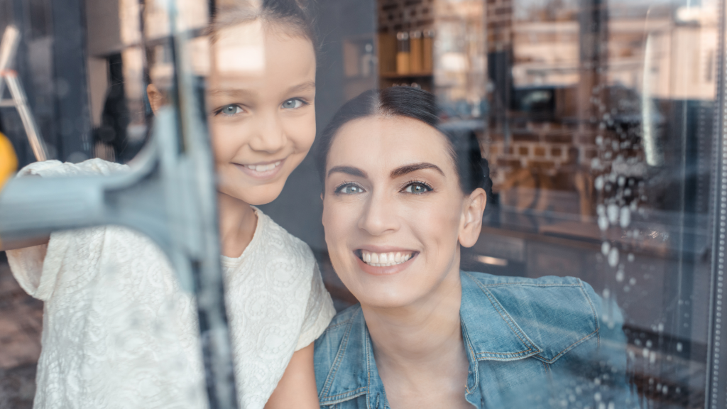 Woman and girl behind a glass window