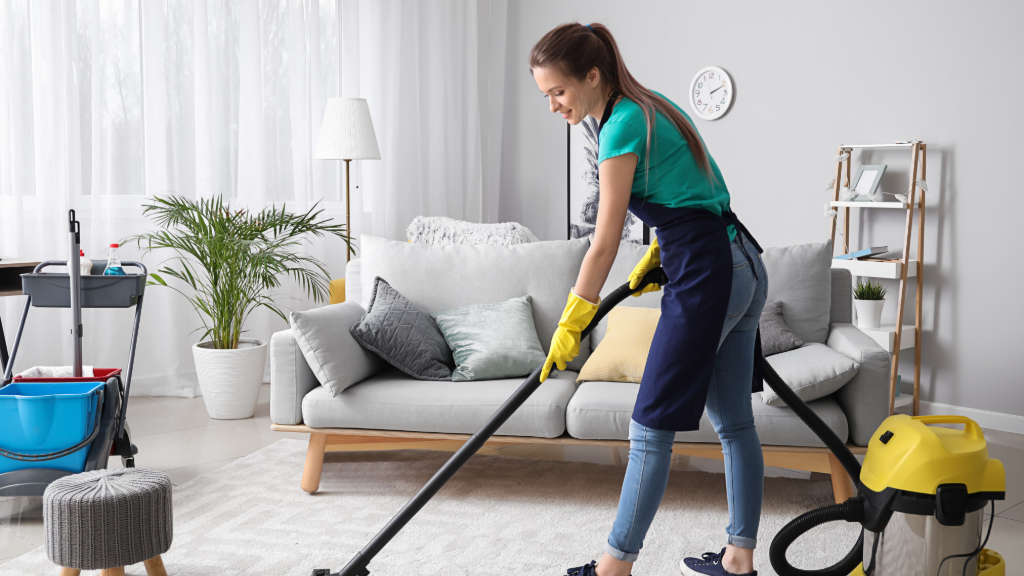 Young woman vacuuming in the living room