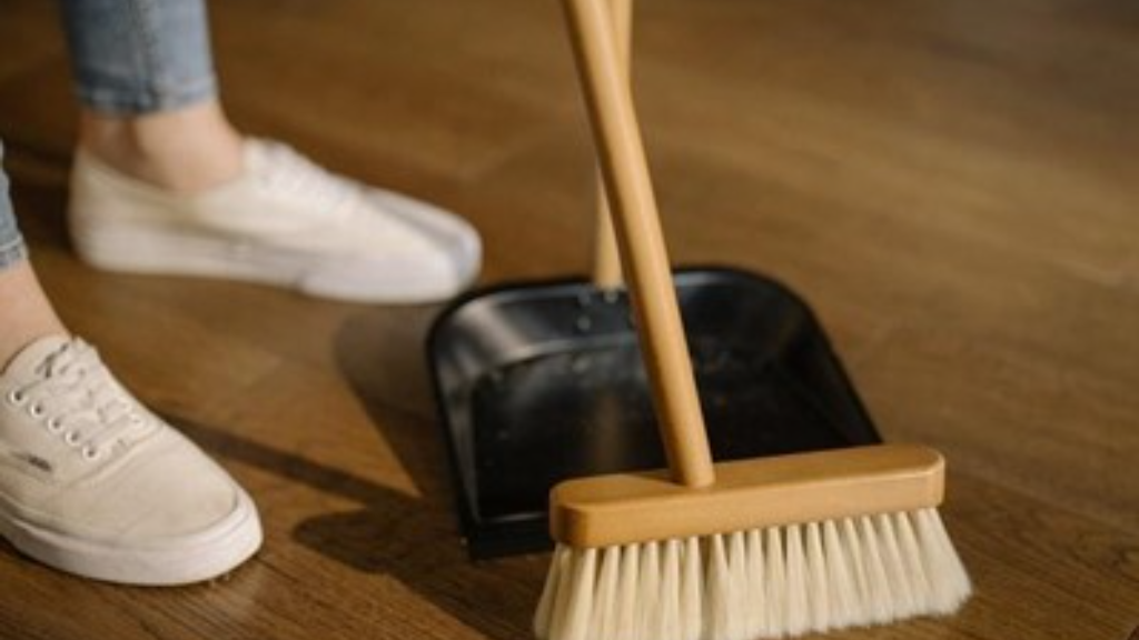 A person cleaning hardwood floors