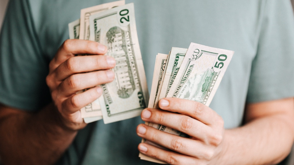 A man counting dollar bills