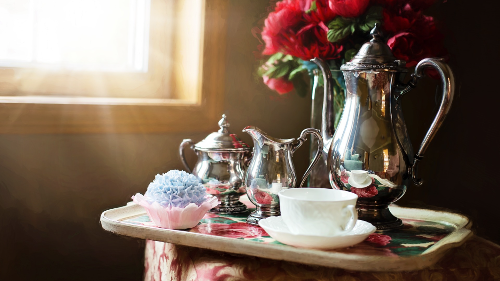Silver tea set with vase of roses