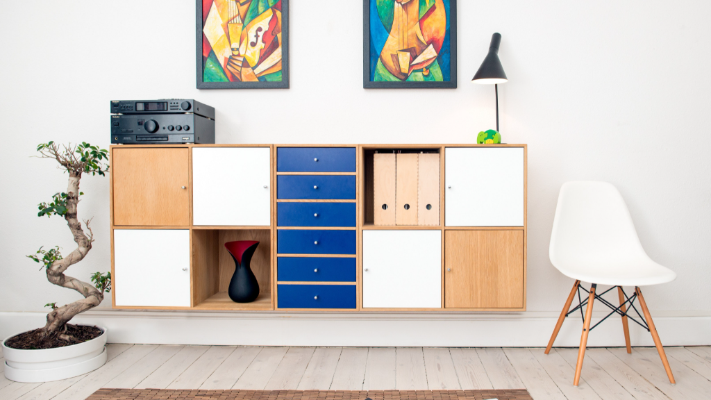 Wall with floating modern bookshelf and Cubist paintings