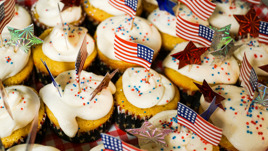 Memorial Day cupcakes with flags, stars, and red, white, and blue sprinkles