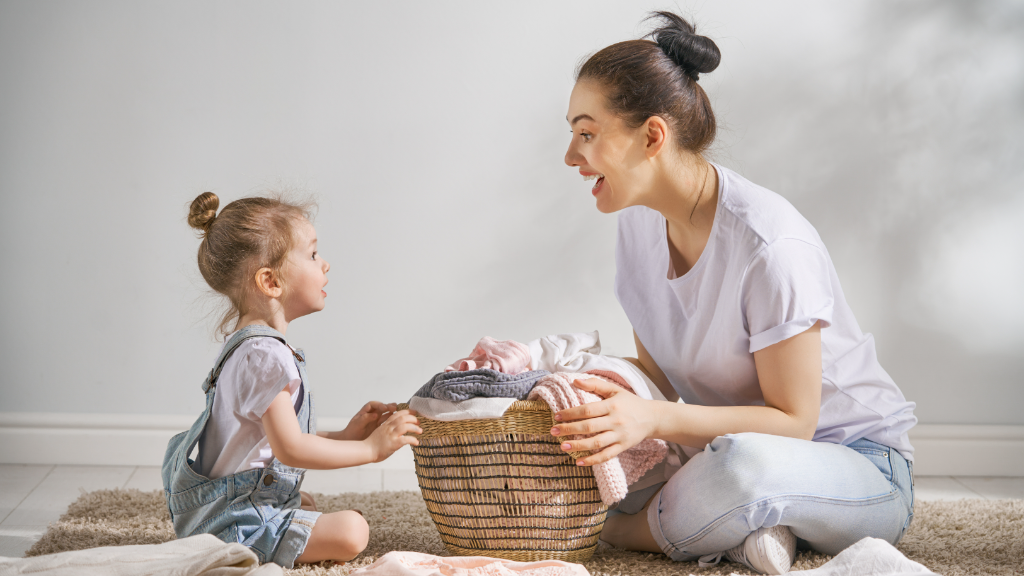 Mother and daughter folding laundry together